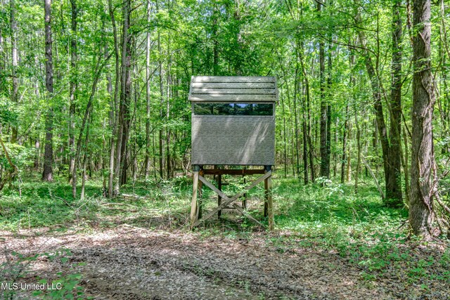 view of outdoor structure with a view of trees