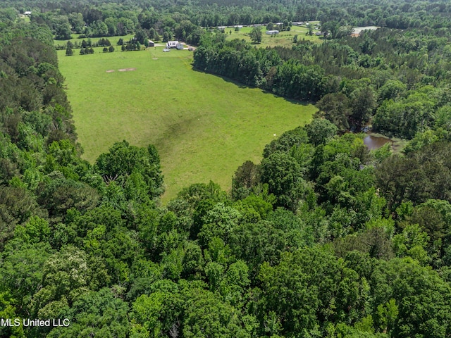 drone / aerial view featuring a forest view