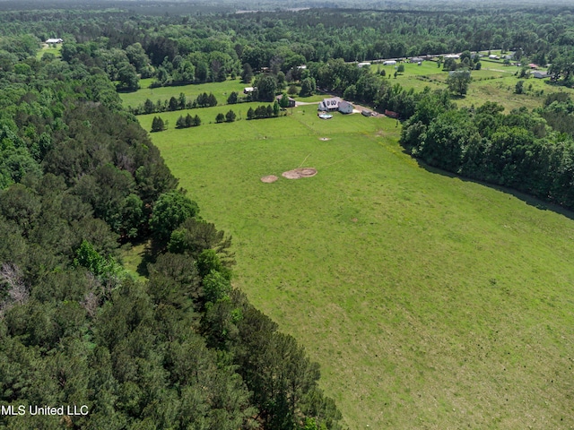 aerial view featuring a rural view and a wooded view