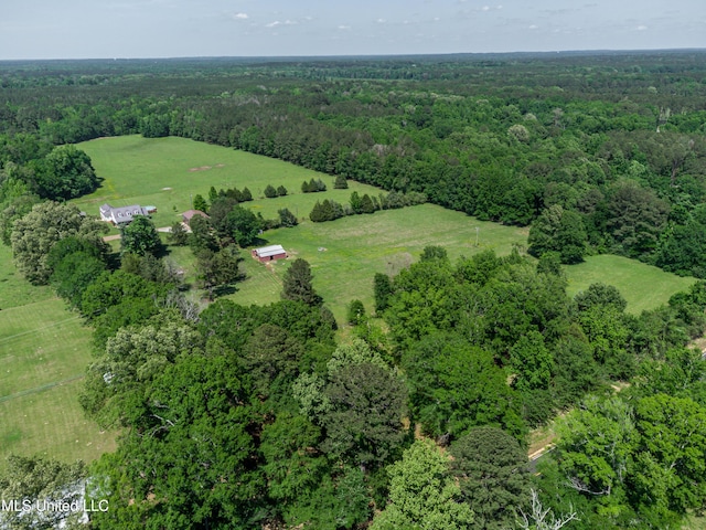 birds eye view of property featuring a view of trees and a rural view