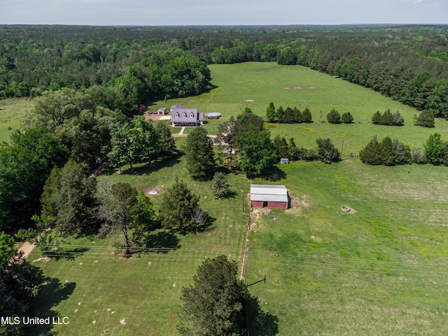 bird's eye view featuring a view of trees and a rural view