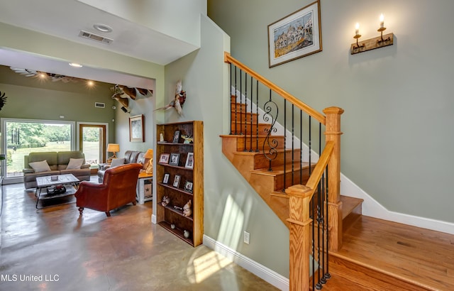 staircase with baseboards and visible vents