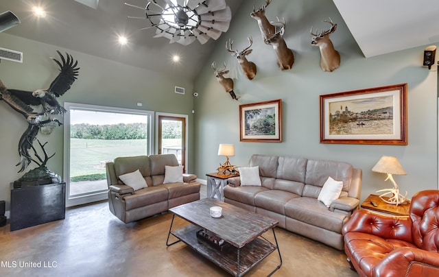 living room with high vaulted ceiling, visible vents, and finished concrete floors