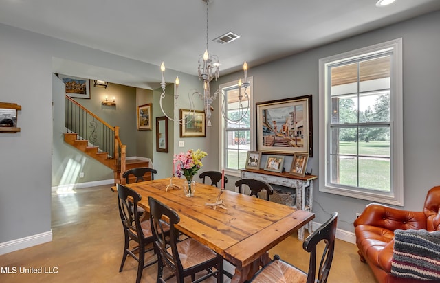dining room with visible vents, baseboards, a wealth of natural light, and stairway