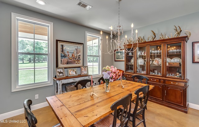 dining area featuring baseboards, a notable chandelier, and plenty of natural light