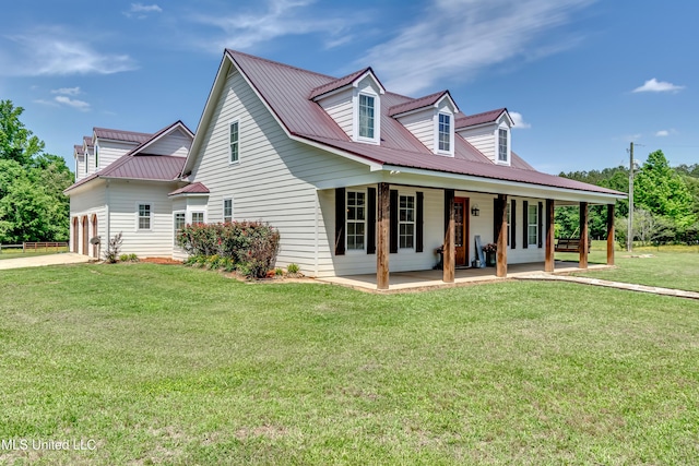 cape cod house with a garage, a front yard, metal roof, a porch, and driveway
