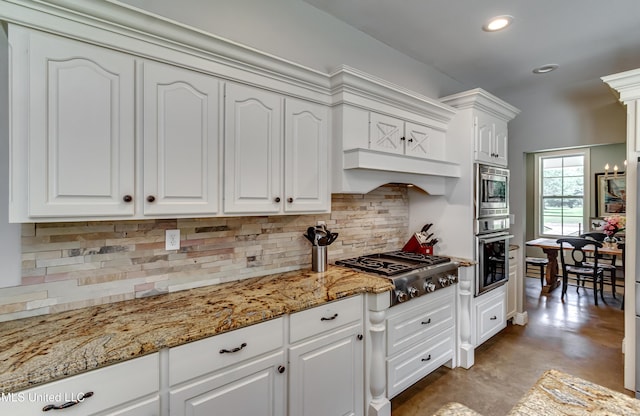kitchen with finished concrete flooring, recessed lighting, white cabinets, tasteful backsplash, and stainless steel appliances