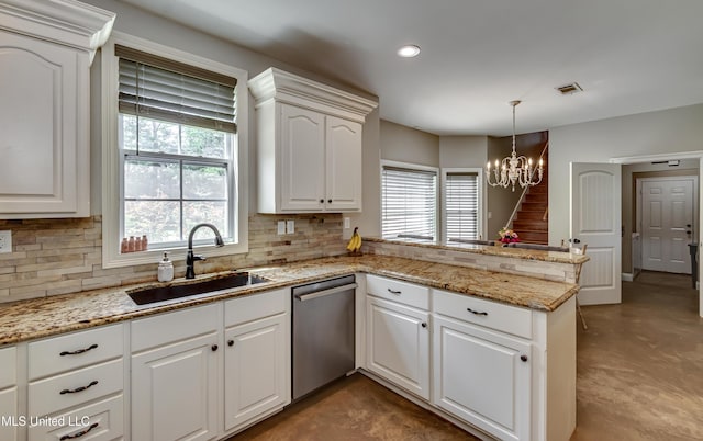 kitchen featuring visible vents, a peninsula, a healthy amount of sunlight, a sink, and dishwasher