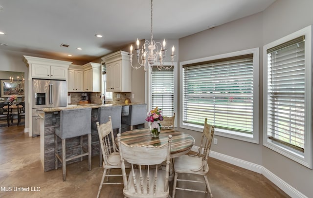 dining room featuring visible vents, baseboards, recessed lighting, a chandelier, and concrete floors