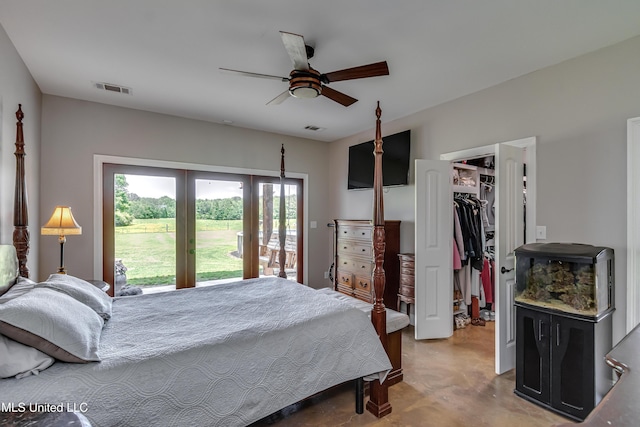 bedroom featuring a spacious closet, a closet, concrete floors, and visible vents