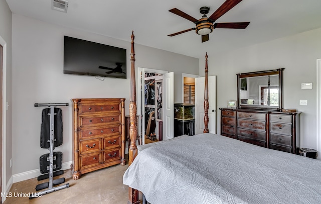 bedroom featuring a walk in closet, a ceiling fan, baseboards, visible vents, and a closet