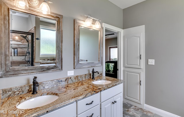 full bathroom featuring plenty of natural light, a sink, and double vanity