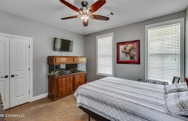 bedroom with ceiling fan, carpet, baseboards, visible vents, and a closet