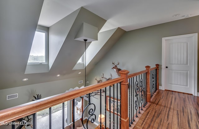 hallway featuring recessed lighting, a skylight, visible vents, and wood finished floors