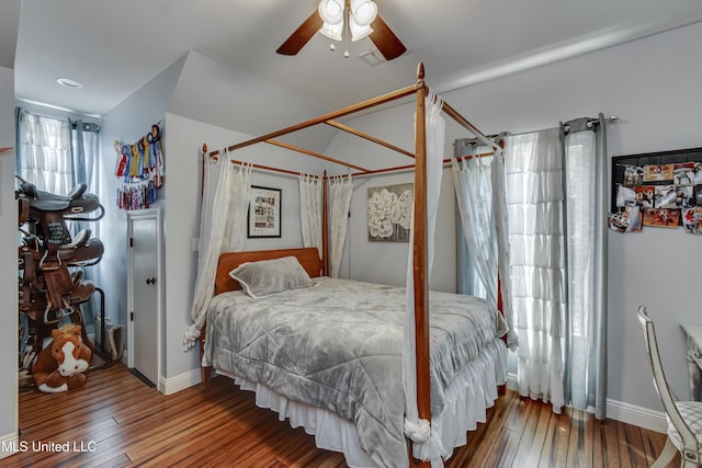 bedroom featuring wood-type flooring, a ceiling fan, and baseboards