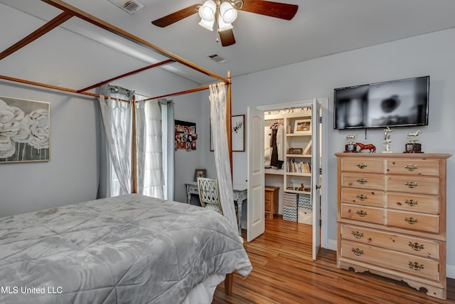 bedroom featuring visible vents, ceiling fan, and wood finished floors