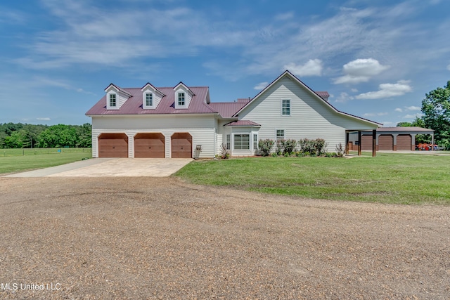 traditional-style house featuring a garage, metal roof, concrete driveway, and a front lawn