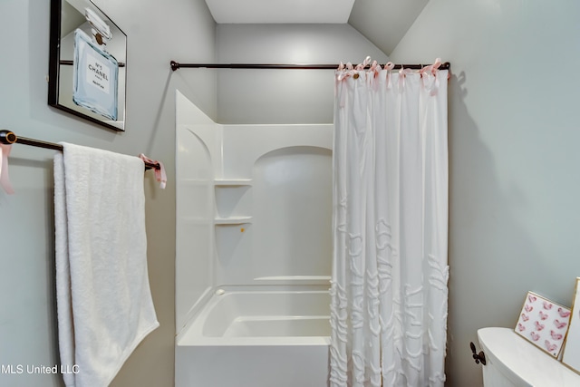 bathroom with shower / bathtub combination with curtain, vaulted ceiling, and toilet