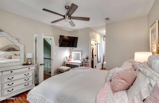 bedroom with visible vents, a ceiling fan, and dark wood-style flooring