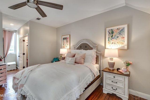 bedroom with baseboards, ceiling fan, visible vents, and wood finished floors