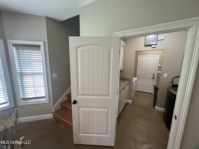 hall with baseboards and stairs