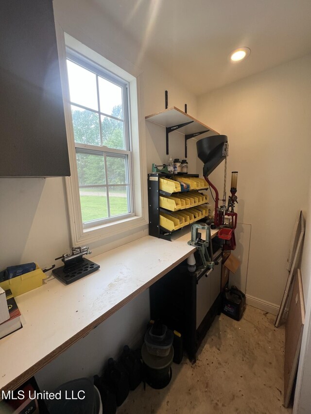 office area featuring baseboards, concrete flooring, and recessed lighting