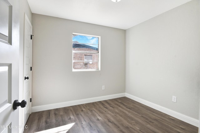 empty room with dark wood-type flooring