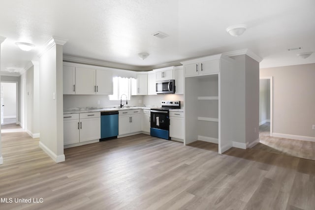 kitchen featuring ornamental molding, light hardwood / wood-style flooring, stainless steel appliances, and white cabinets