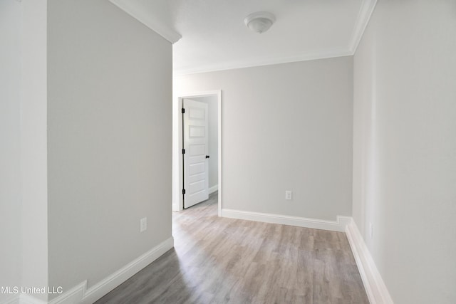 unfurnished room featuring ornamental molding and wood-type flooring