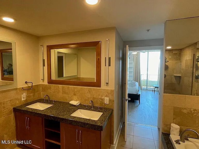 2060 Beach Blvd Unit 1206, Biloxi, MS 39531 - bathroom featuring tile walls, tile patterned flooring, double vanity, a garden tub, and tiled shower