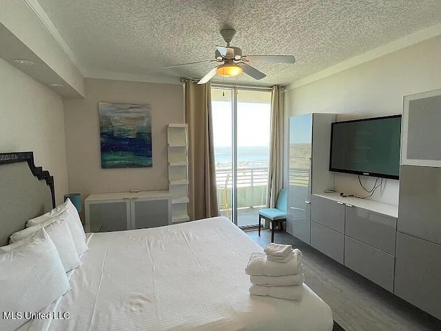 2060 Beach Blvd Unit 1206, Biloxi, MS 39531 - bedroom with a textured ceiling, a ceiling fan, a wall of windows, and wood finished floors