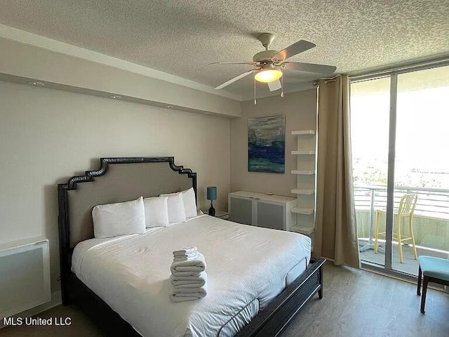 2060 Beach Blvd Unit 1206, Biloxi, MS 39531 - bedroom featuring access to exterior, wood finished floors, a textured ceiling, expansive windows, and ceiling fan