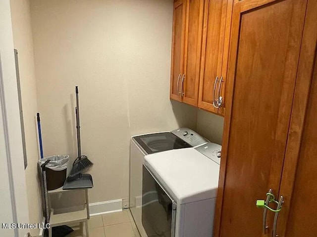 2060 Beach Blvd Unit 1206, Biloxi, MS 39531 - washroom with cabinet space, washer and clothes dryer, and tile patterned floors
