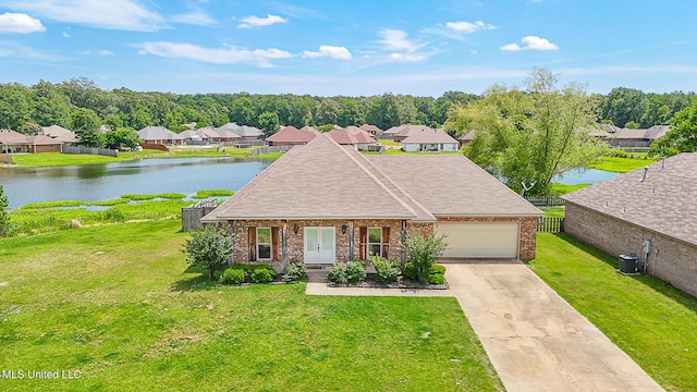 view of front of home featuring a front lawn, a garage, a water view, french doors, and driveway