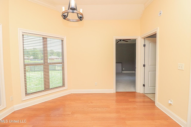 unfurnished room featuring baseboards, ornamental molding, and light wood-style flooring