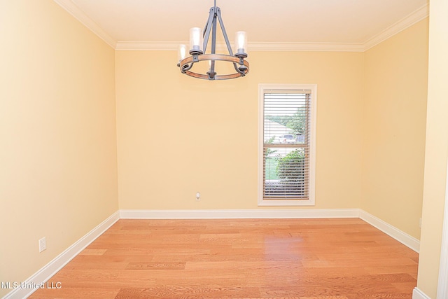 unfurnished room with crown molding, light wood finished floors, baseboards, and a notable chandelier