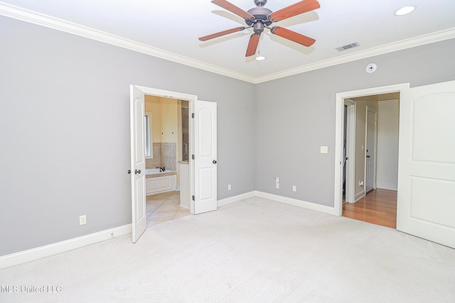 unfurnished bedroom with light colored carpet, ornamental molding, and baseboards
