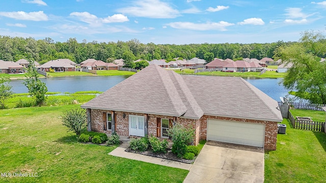 view of front of house with a water view, an attached garage, driveway, and brick siding