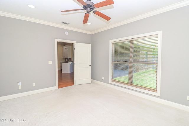 unfurnished bedroom featuring crown molding, carpet floors, recessed lighting, baseboards, and visible vents