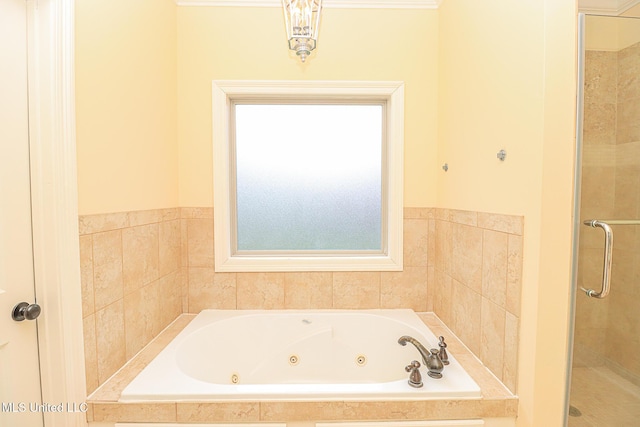 full bathroom featuring a whirlpool tub and a stall shower