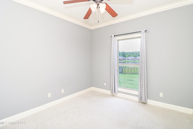 carpeted empty room featuring ceiling fan, ornamental molding, and baseboards
