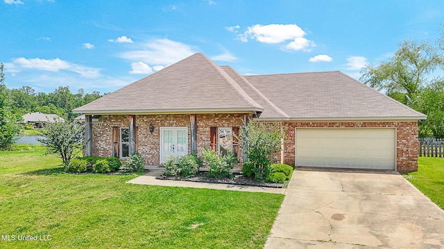 view of front of house featuring a shingled roof, a front lawn, brick siding, a garage, and concrete driveway