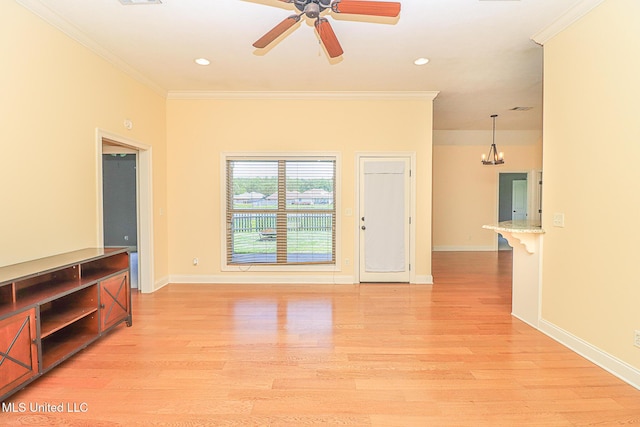 unfurnished living room with baseboards, ornamental molding, recessed lighting, and light wood-style flooring