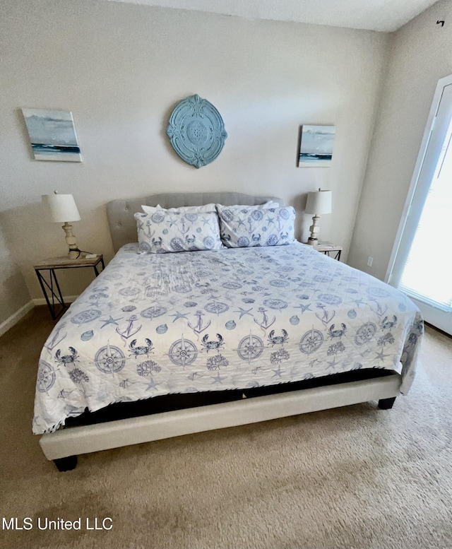 bedroom with baseboards and carpet