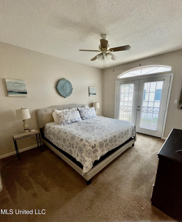 carpeted bedroom with access to outside, a ceiling fan, a textured ceiling, and baseboards