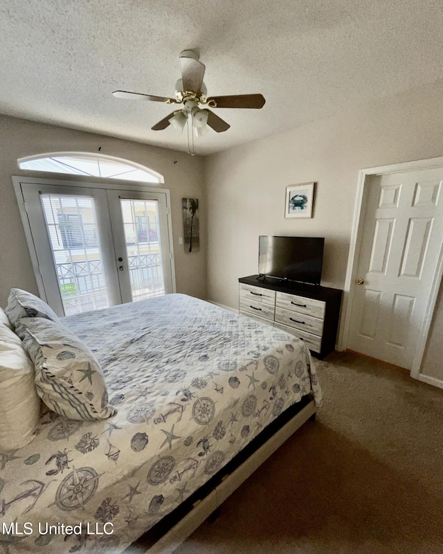 carpeted bedroom featuring access to outside, a textured ceiling, a ceiling fan, and french doors