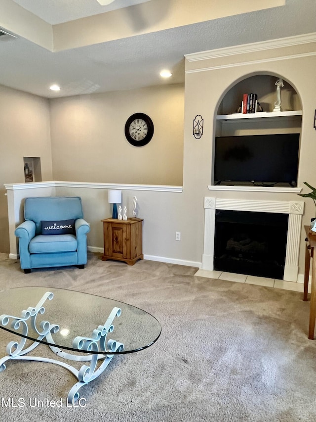 living area with carpet floors, ornamental molding, baseboards, recessed lighting, and a fireplace with flush hearth