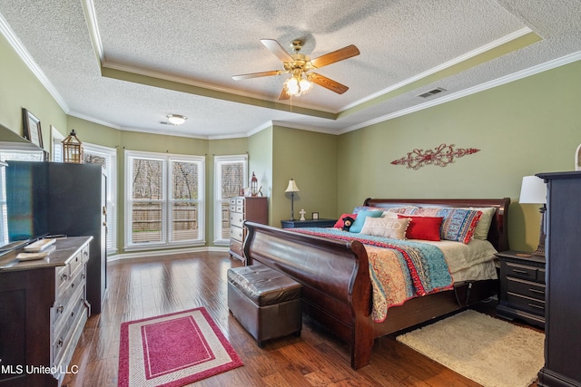 9476 Plantation Rd, Olive Branch, MS 38654 - bedroom featuring visible vents, ornamental molding, a raised ceiling, and hardwood / wood-style floors