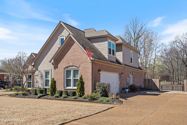 9476 Plantation Rd, Olive Branch, MS 38654 - view of home's exterior with driveway, a gate, fence, an attached garage, and brick siding