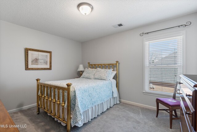 9476 Plantation Rd, Olive Branch, MS 38654 - carpeted bedroom featuring visible vents, baseboards, and a textured ceiling